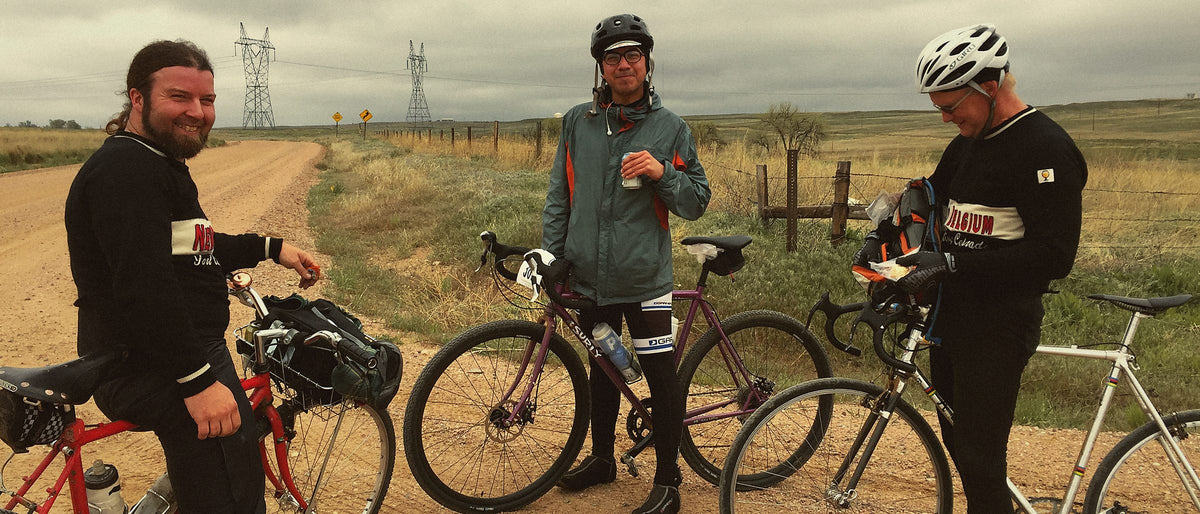 Riders with Mesa coffee on a gravel road